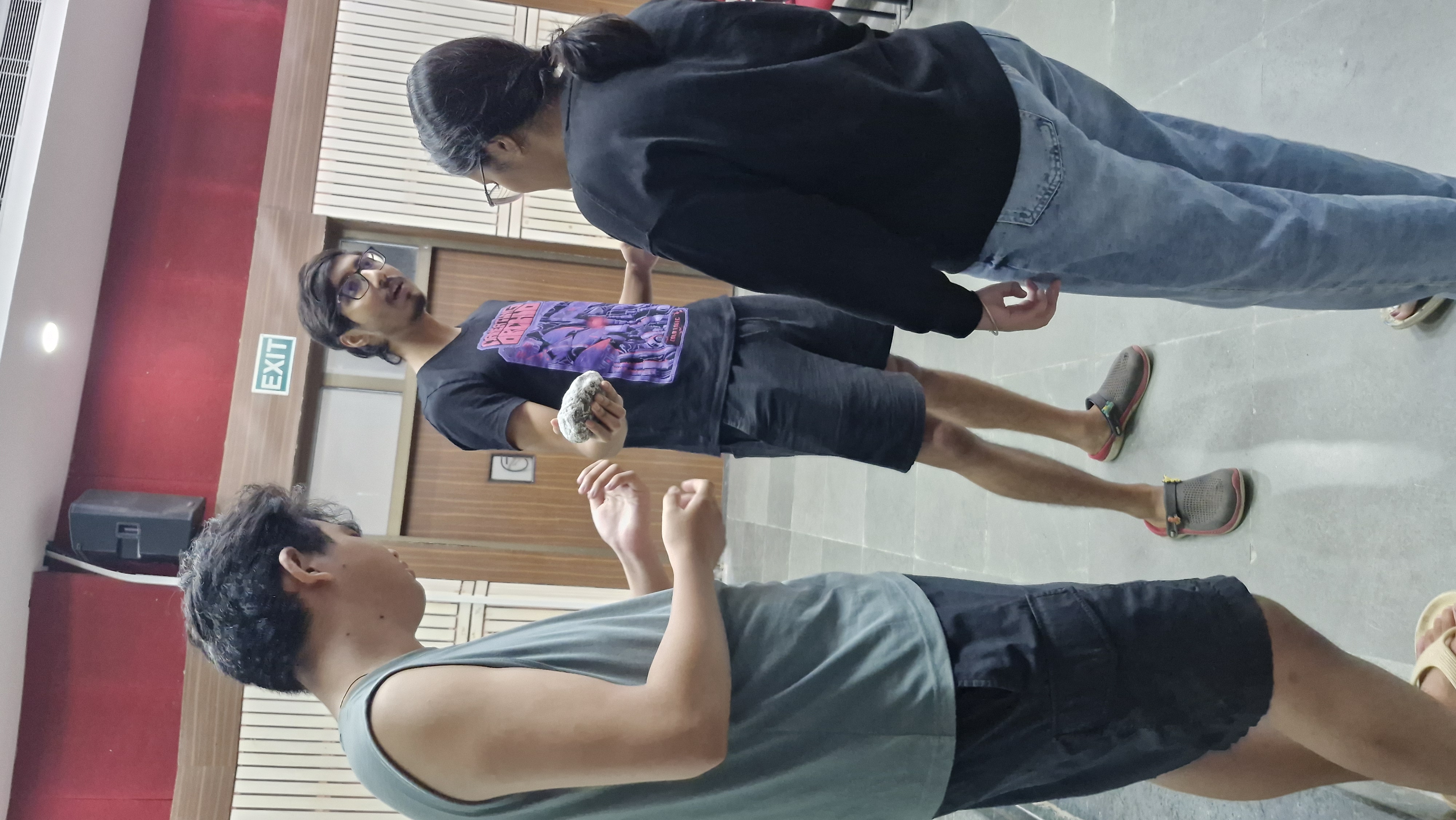 Students discussing a rock specimen together
